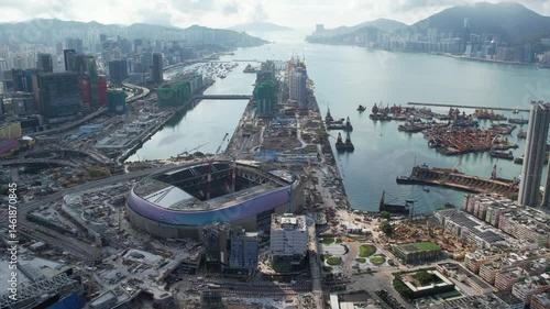 Drone flight above Kai Tak in its development process, surrounded by sea and city skyline