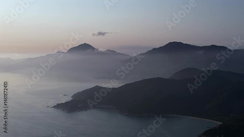 Drone scenic view of Early morning mist over the island on Lantau with dark terrain in Hong Kong