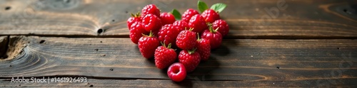 Vibrant berries in the shape of a heart on natural wooden backdrop, farm fresh, agriculture, decorative