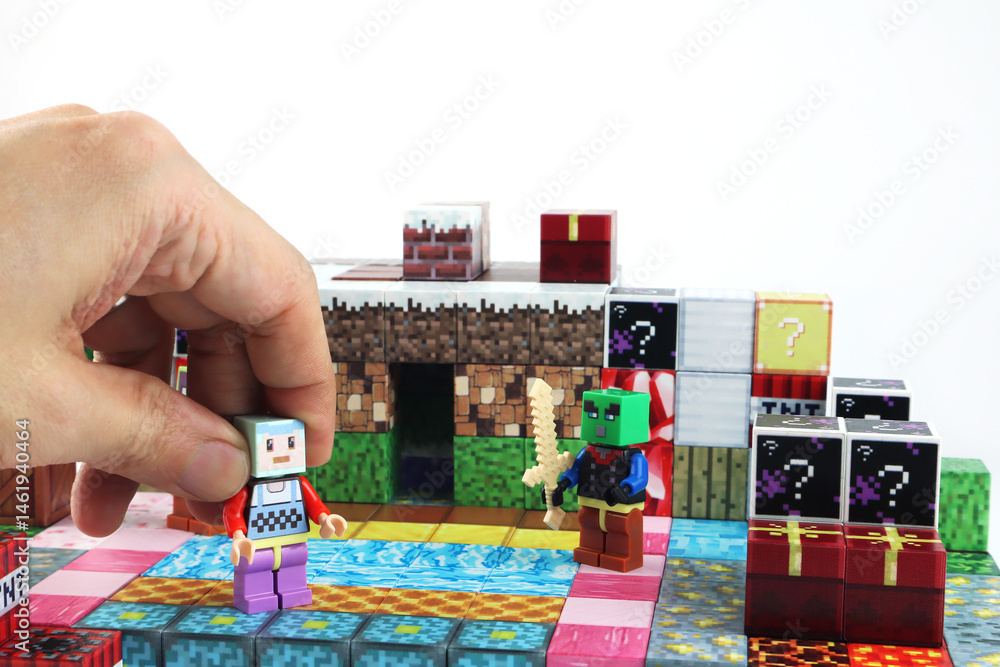 Naklejka premium minecraft magnetic building toy blocks , from online virtual world game series are display on white table with many kinds of minecraft blocks , tnt magma stone wood grass water and cute characters