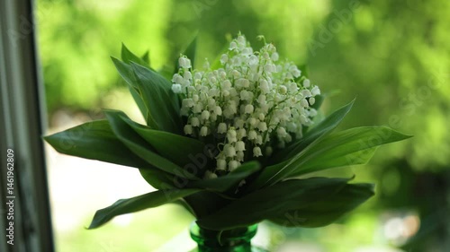 A bouquet of fresh lilies of the valley in a vase. Close-up. Selective focus