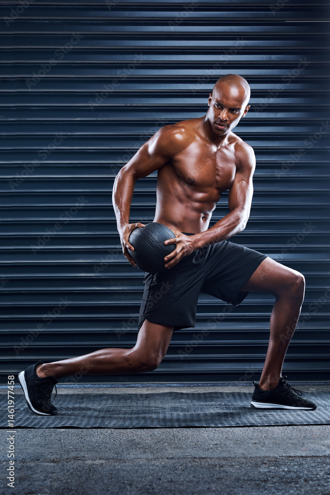 Obraz premium Male athlete, workout and lunges with medicine ball for sports, exercise and fitness in gym. Healthy man, topless and cardio routine for wellness, muscle and strength training for mental wellbeing