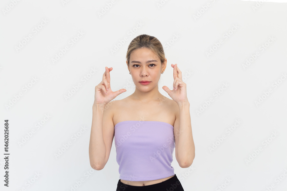 young asian woman with fingers crossing isolated on white background young asian woman with fingers crossing isolated on white background