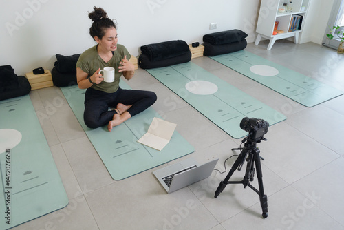 young female yoga instructor in a live broadcast on social media.