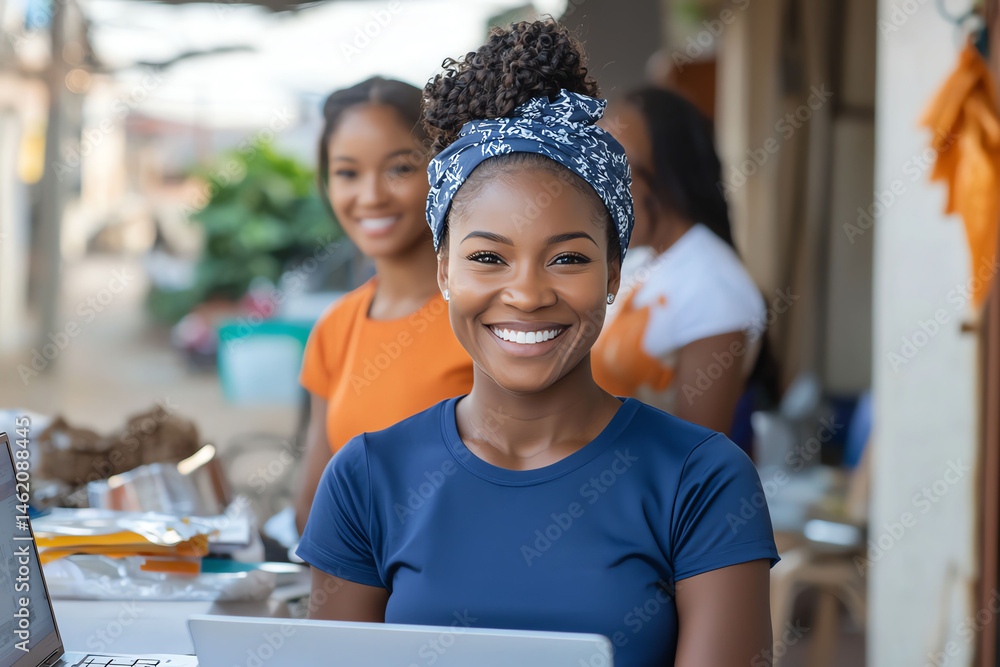 A joyful young woman working on a laptop outdoors, showcasing community spirit. Behind her, friends contribute to a vibrant atmosphere, highlighting collaboration and positivity.