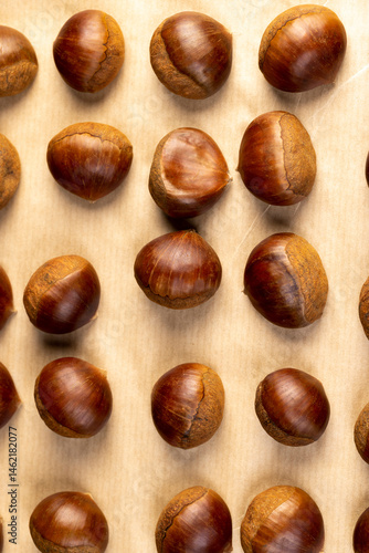 Wallpaper Mural chestnut fruits for frying or baking , preparation by cutting the shells of edible chestnut nuts, top view Torontodigital.ca