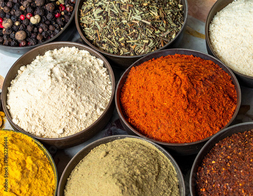 The diverse textures and colors of spices commonly used in Ecuadorian cooking, arranged artfully.