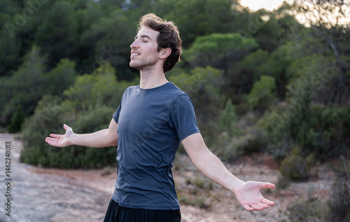 Valokuva Happy man opens his arms feeling freedom outdoors, feeling of health, well-being