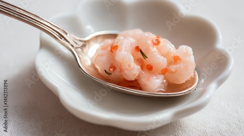 Obraz na płótnie Delicate shrimp dish served on a silver spoon, white isolated background. w salonie