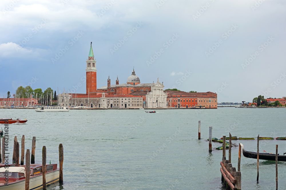 ancient bell tower of Church called SAN GIORGIO in Venice Island in Italy and canal of Giudecca