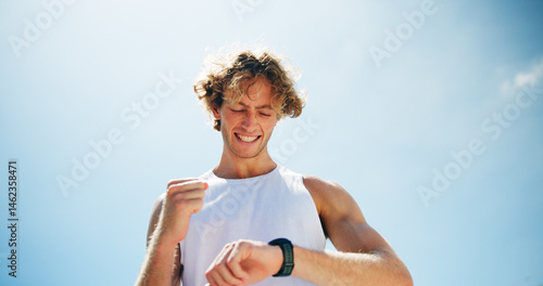 Smile, outdoor and man with fitness, smart watch and track progress with space, cheering and exercise. Person, runner and athlete with training, check cardio and excited with wellness and challenge photo