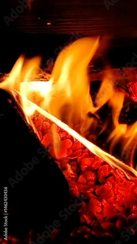 Vertical video, with a fire in a wood stove for warmth