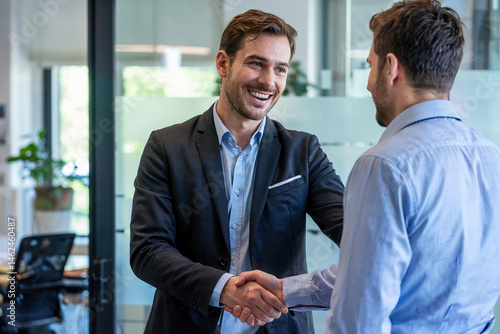 Two businessmen greet each other.
