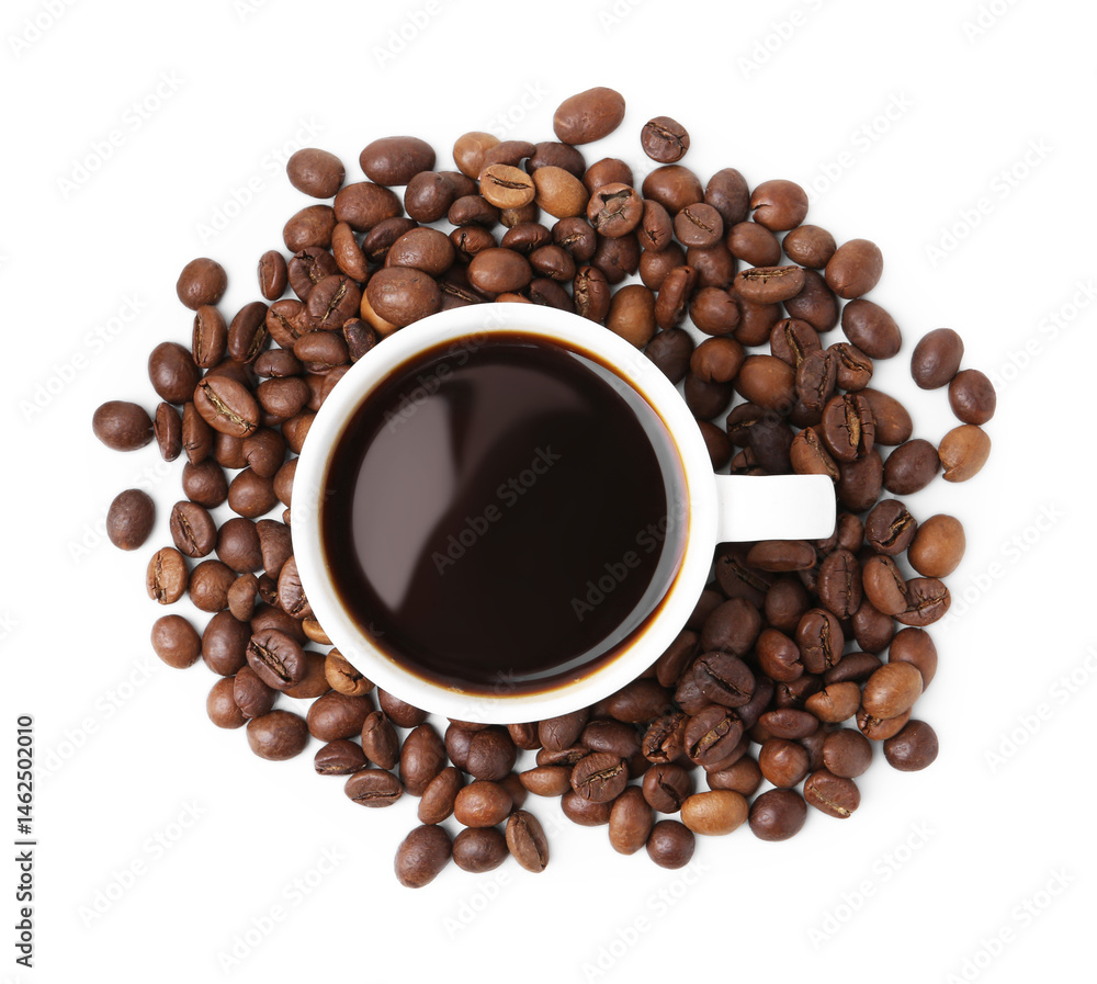 Obraz premium Aromatic coffee in cup and pile of beans isolated on white, top view
