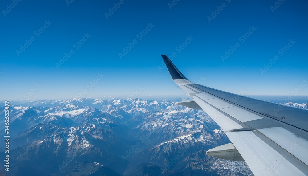 Obraz premium High mountain peaks seen from an airplane window