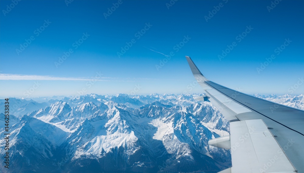 Fototapeta premium High mountain peaks seen from an airplane window