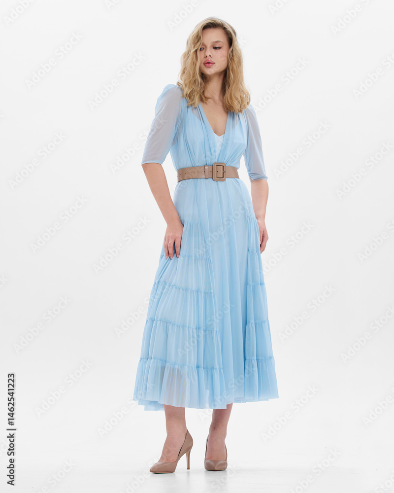 Naklejka premium Girl model in blue dress on white studio background.