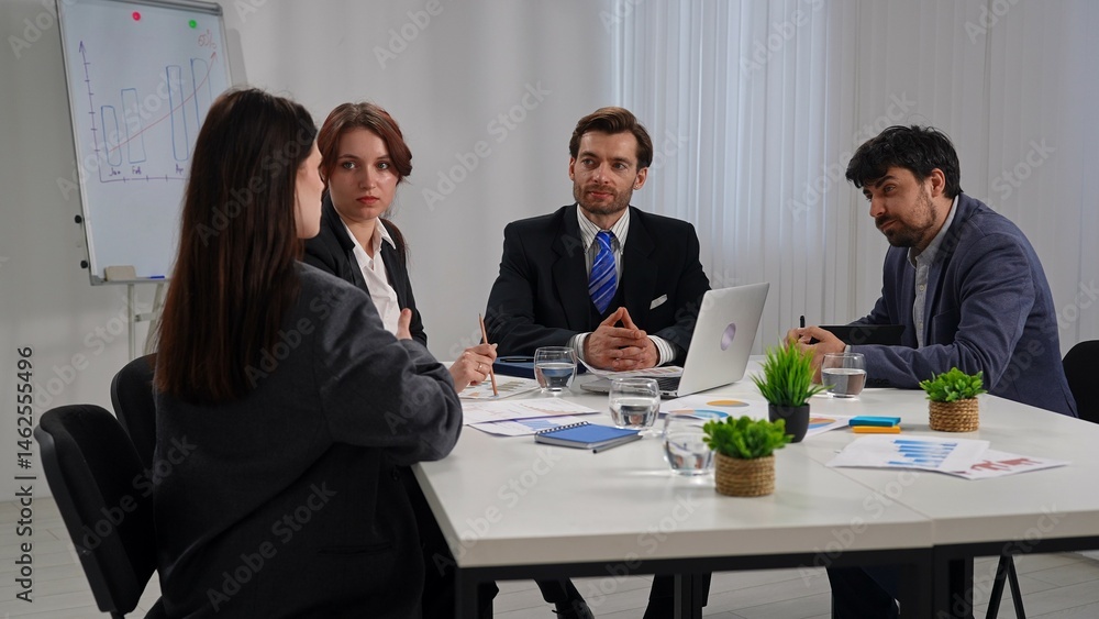 Business Meeting with Four People in Office Setting Business Meeting with Four People in Office Setting