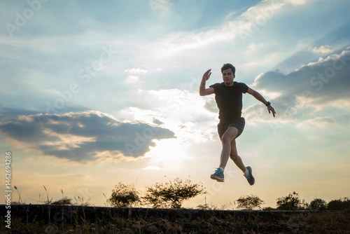 Wallpaper Mural Silhouette of a man running against a colorful sky. Silhouette of a man running against a sunset background. Torontodigital.ca