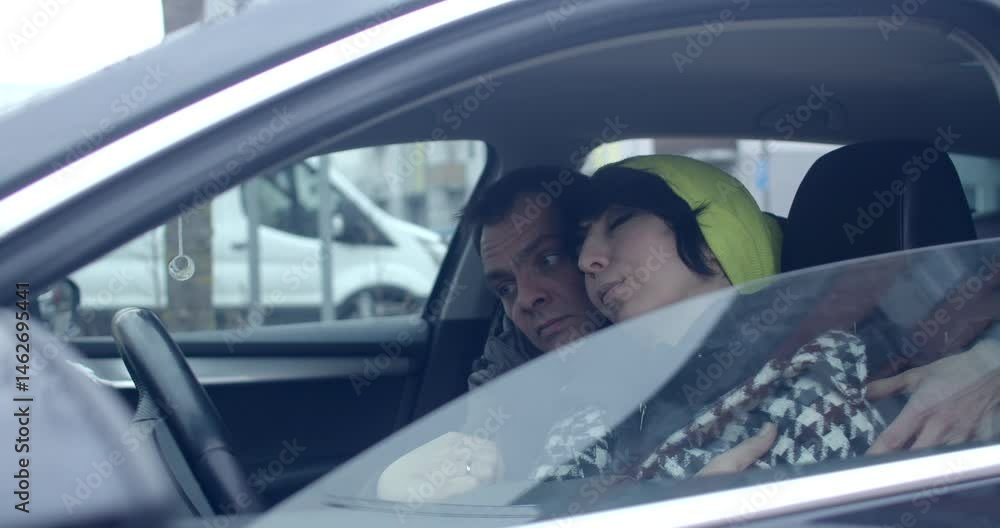 Two people are having an interesting conversation in a car, with an urban background visible outside Two people are having an interesting conversation in a car, with an urban background visible outside
