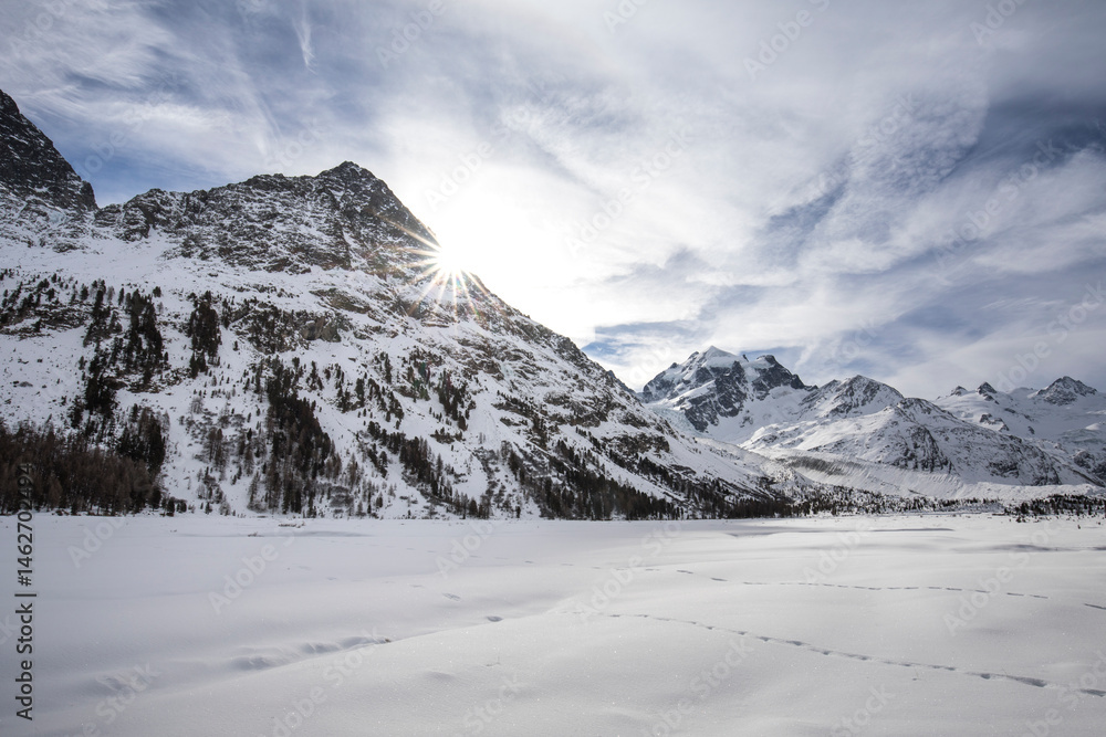 Obraz premium View of the Graubünden mountains Piz Roseg and Pia Bernina in the Roseg Valley in winter. Snow covered landscape. Swiss Mountains.