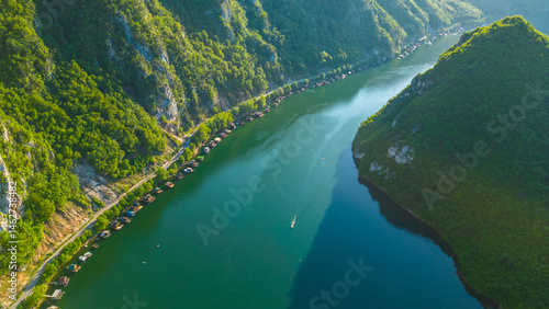 Wallpaper Mural Aerial view of Lake Perućac in Tara National Park, Serbia. Stunning emerald waters, houseboats lined along the shoreline, and lush forested hills create a peaceful and scenic mountain escape Torontodigital.ca