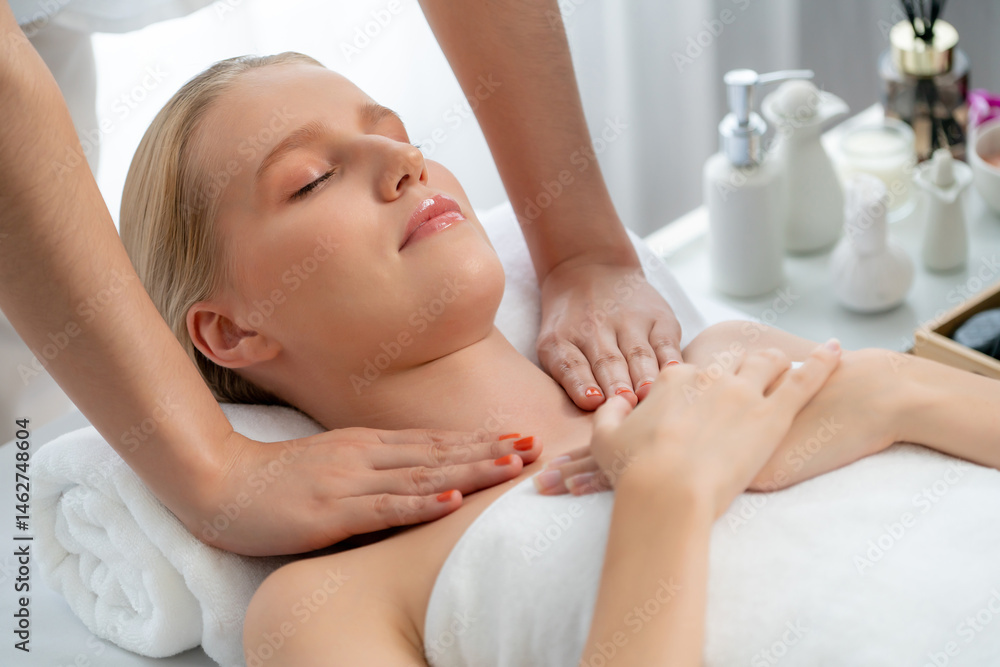 Caucasian woman customer enjoying relaxing anti-stress spa massage and pampering with beauty skin recreation leisure in day light ambient salon spa at luxury resort or hotel. Quiescent Caucasian woman customer enjoying relaxing anti-stress spa massage and pampering with beauty skin recreation leisure in day light ambient salon spa at luxury resort or hotel. Quiescent