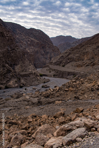 Obraz na płótnie Oman, 03-06-2025: canyon and view of the winding road to Jebel Al Harim (Jabal Al Harim), the highest mountain (2,087 metres), located in the Hajar Mountains range, of the Musandam Peninsula w salonie