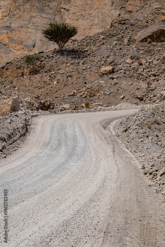 Obraz na płótnie Oman, 03-06-2025: canyon and view of the winding road to Jebel Al Harim (Jabal Al Harim), the highest mountain (2,087 metres), located in the Hajar Mountains range, of the Musandam Peninsula w salonie