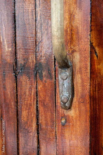 Obraz na płótnie close-up of aged brass handle on varnished wooden surface. w salonie