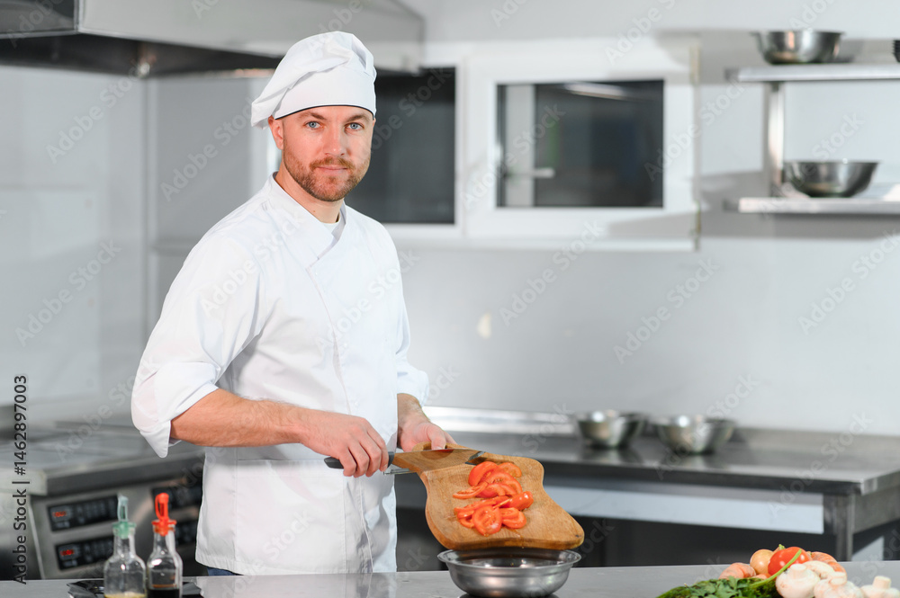 Chef in uniform cooking at the restaurant kitchen Chef in uniform cooking at the restaurant kitchen