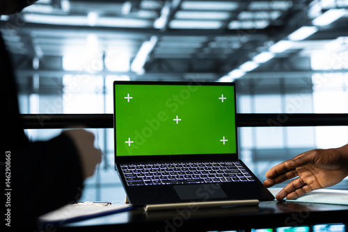 Obraz na płótnie Programmers in data center using mockup laptop, inspecting server rigs, updating network topologies. Close up of IT coworkers brainstorming, using chroma key notebook, ensuring stable operations w salonie