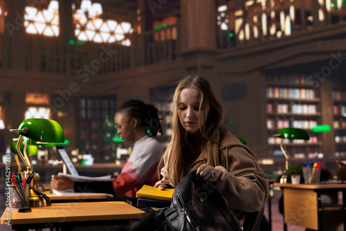 College student borrowing some books to study for upcoming exams from the university campus library, does research for a school assignment. Young girl with dedication does self learning.
