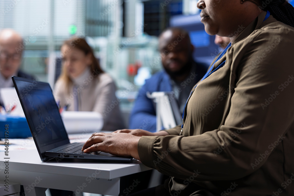 Factory management and shareholders work on manufacturing automation innovations using notebook, close up. Industrial plant managers and investors analyze production research data using laptop