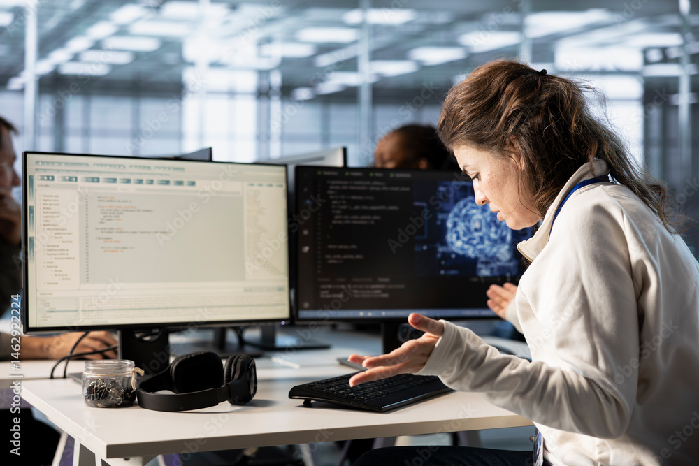 Frustrated technician annoyed after keyboard stopped working in data center while writing code on PC. Mad IT professional in server hub upset after computer peripherals got broken