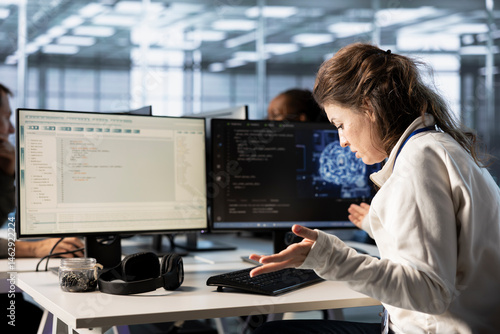 Obraz na płótnie Frustrated technician annoyed after keyboard stopped working in data center while writing code on PC. Mad IT professional in server hub upset after computer peripherals got broken w salonie