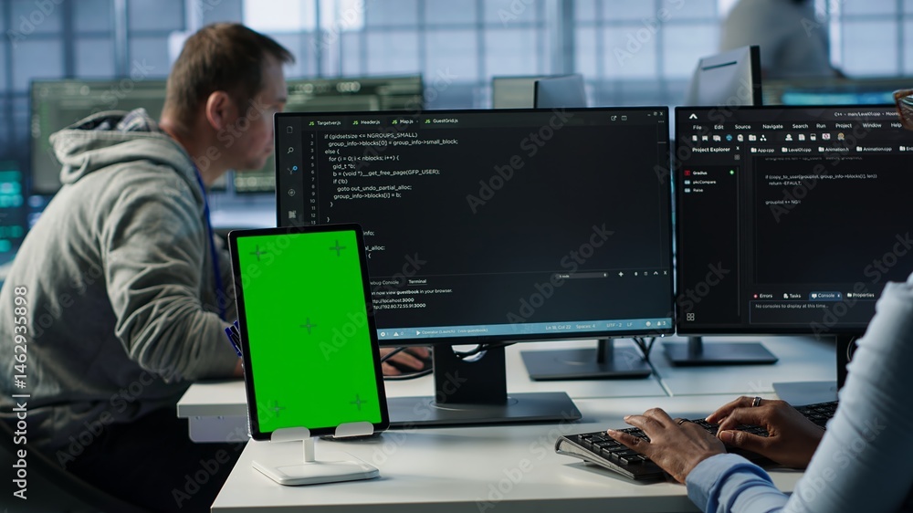 Green screen table in data center in front of IT support specialists working together, supervising server rows. Employees overseeing supercomputers using mockup device, camera A