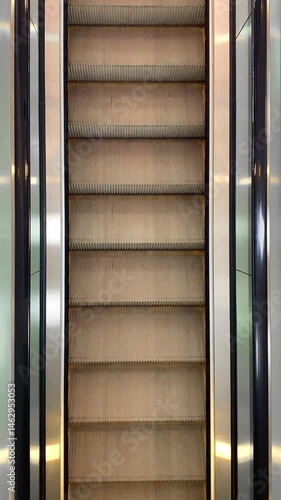 Empty moving escalator in a shop mall. Top view. Close-up.