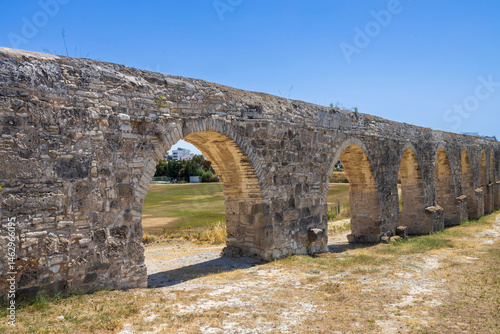 Larnaca, Cyprus, 8 May 2025, The ancient Kamares Aqueduct stretches across the landscape under a clear sky in Larnaca, Cyprus.
