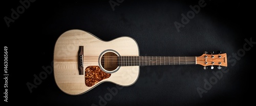 Acoustic guitar on black background. Wooden instrument with intricate detailing, including strings and soundhole