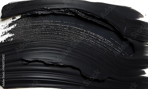 Dark, smudged black cosmetic strokes on white background.  Detailed texture visible