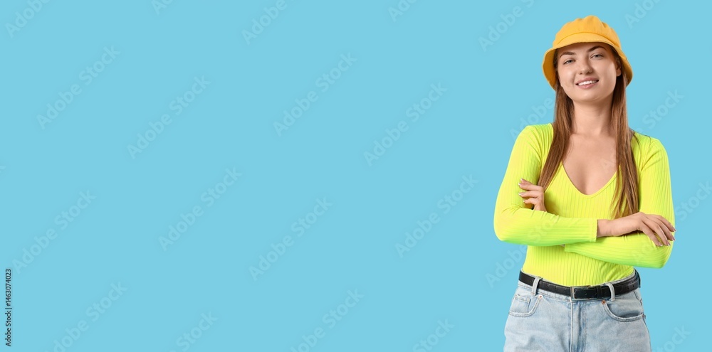 Young woman in bucket hat on blue background with space for text Young woman in bucket hat on blue background with space for text