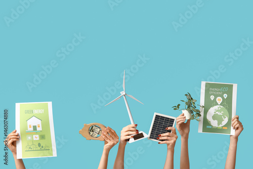 Many hands with wind turbin...