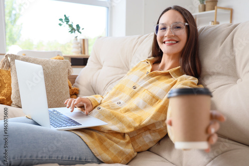 Young woman with laptop and...