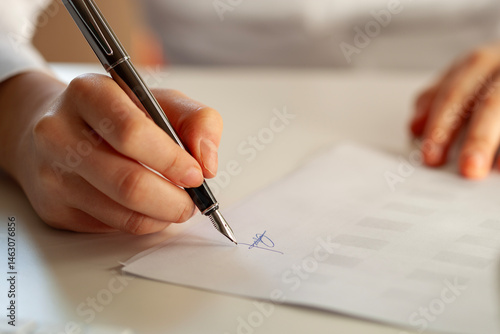 woman signing a real estate contract