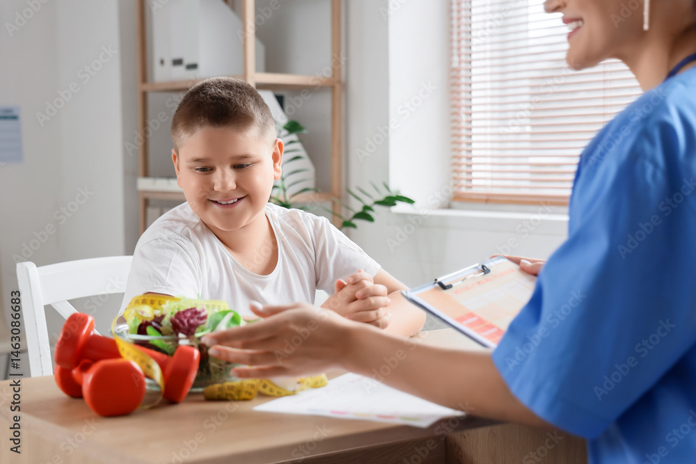 Overweight boy visiting nutritionist in clinic. Diet concept Overweight boy visiting nutritionist in clinic. Diet concept