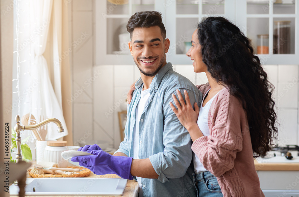 custom made wallpaper toronto digitalLoving Arab Wife Embracing Her Husband While He Washing Dishes In Kitchen, Happy Middle Eastern Woman Grateful For Help With Domestic Chores. Young Family Cleaning Plates After Lunch At Home