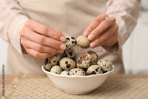 Hands arranging fresh quail...