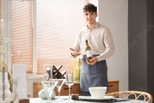 Male waiter showing bottle ...