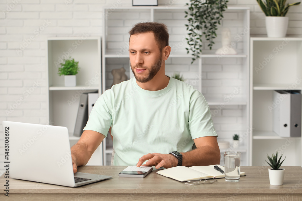 Male accountant calculating in modern office Male accountant calculating in modern office